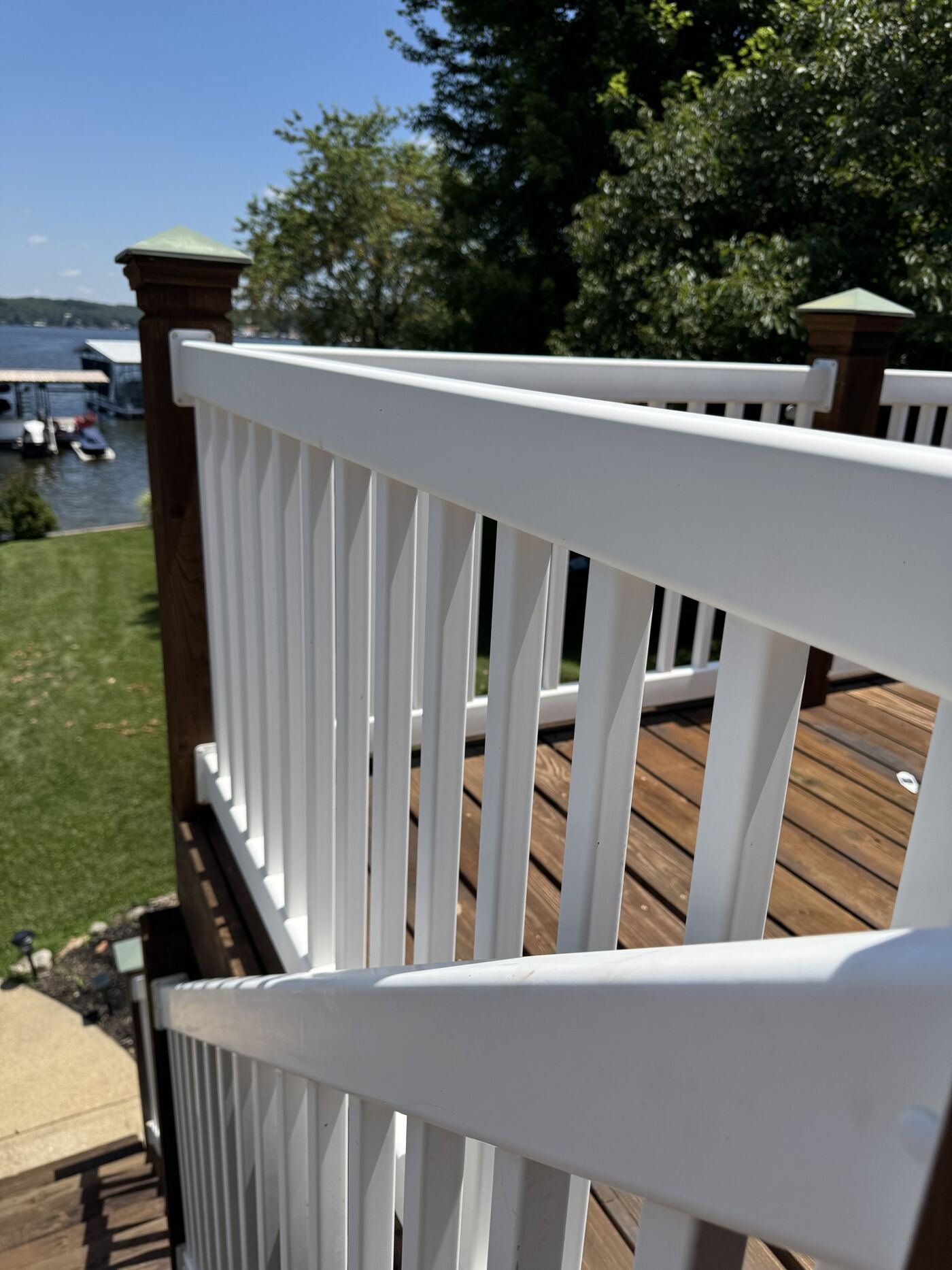 Hand-finished white rail and stained deck boards detail